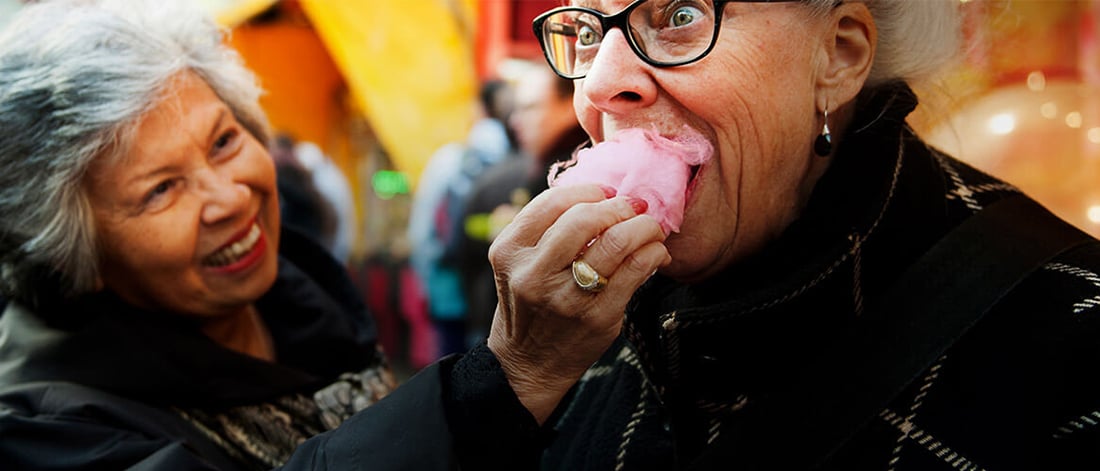 two women eating candy floss