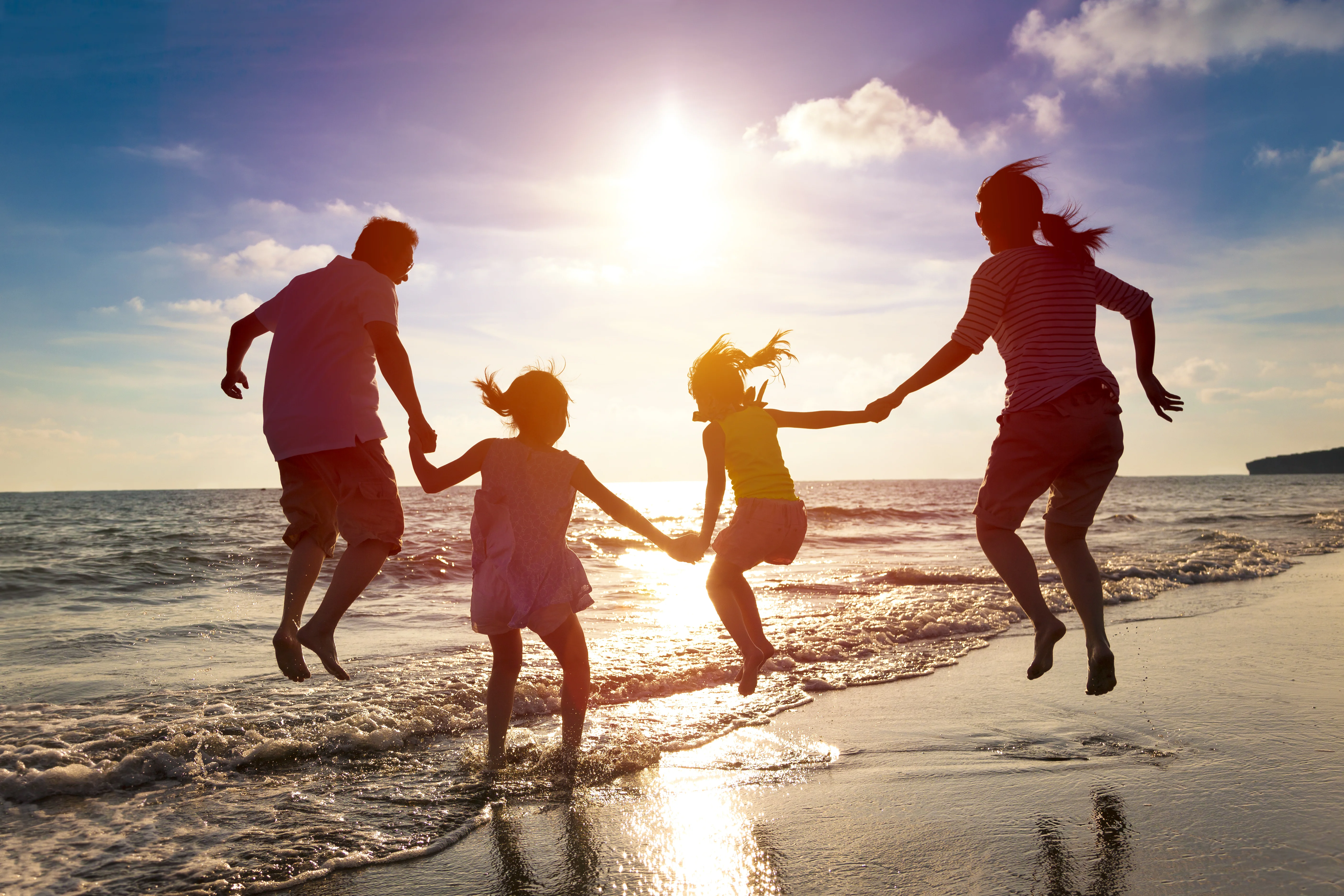 a family running on the beach
