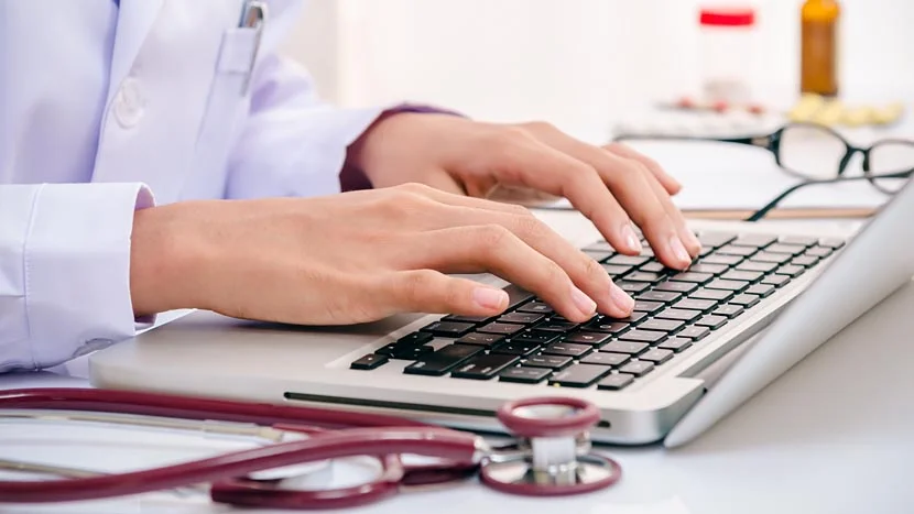 a person typing on a laptop