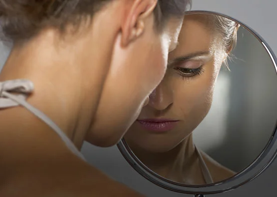 a person looking at a mirror